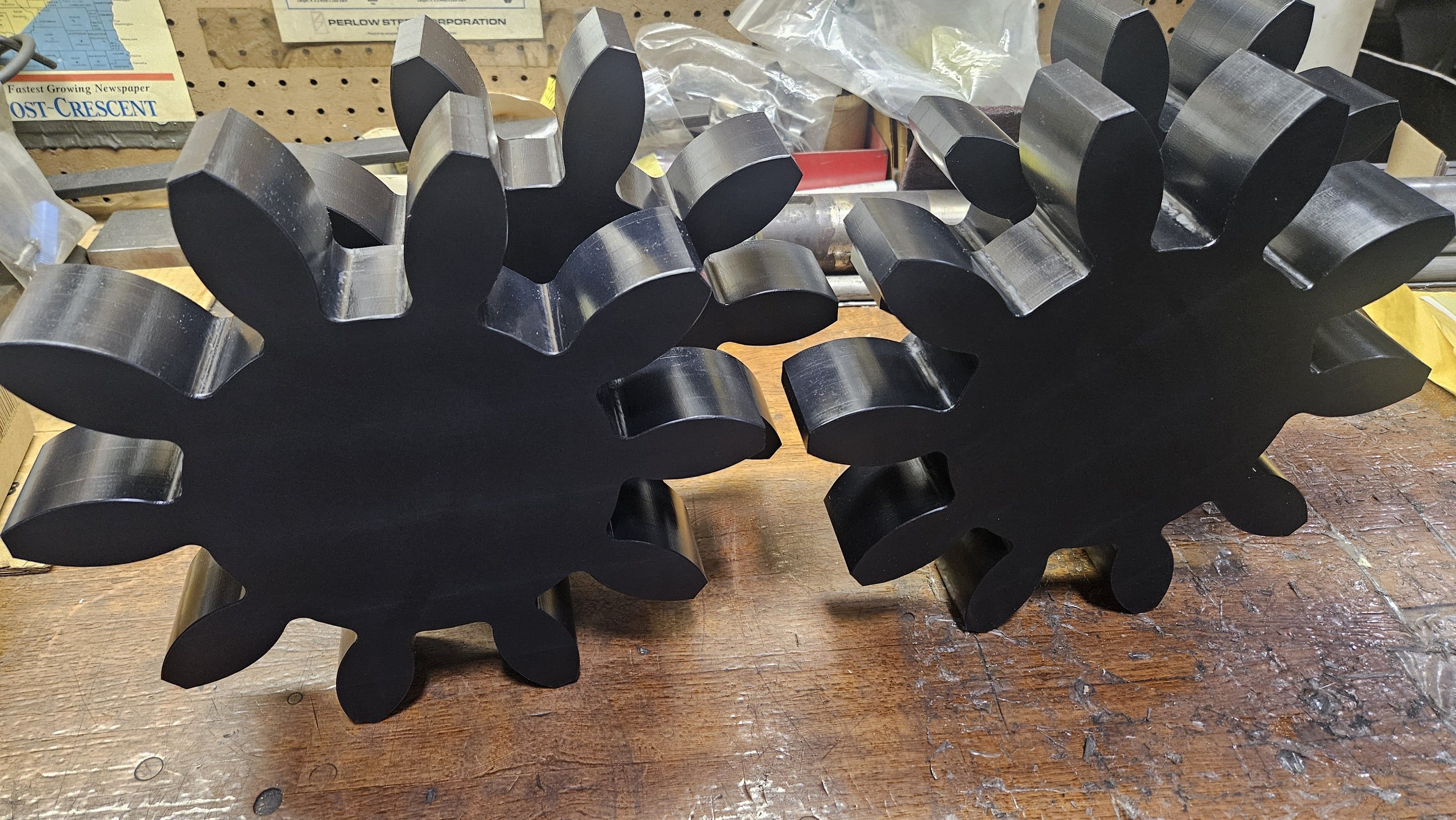 Two matching black powder-coated star-shaped steel plates ready for assembly