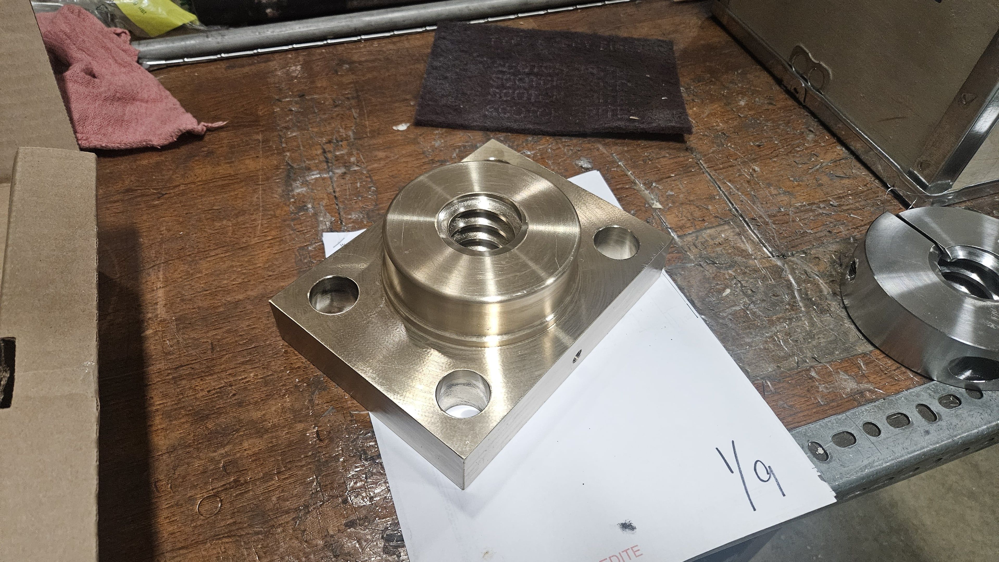 Machined bronze flange plate with a threaded acme-nut center bore