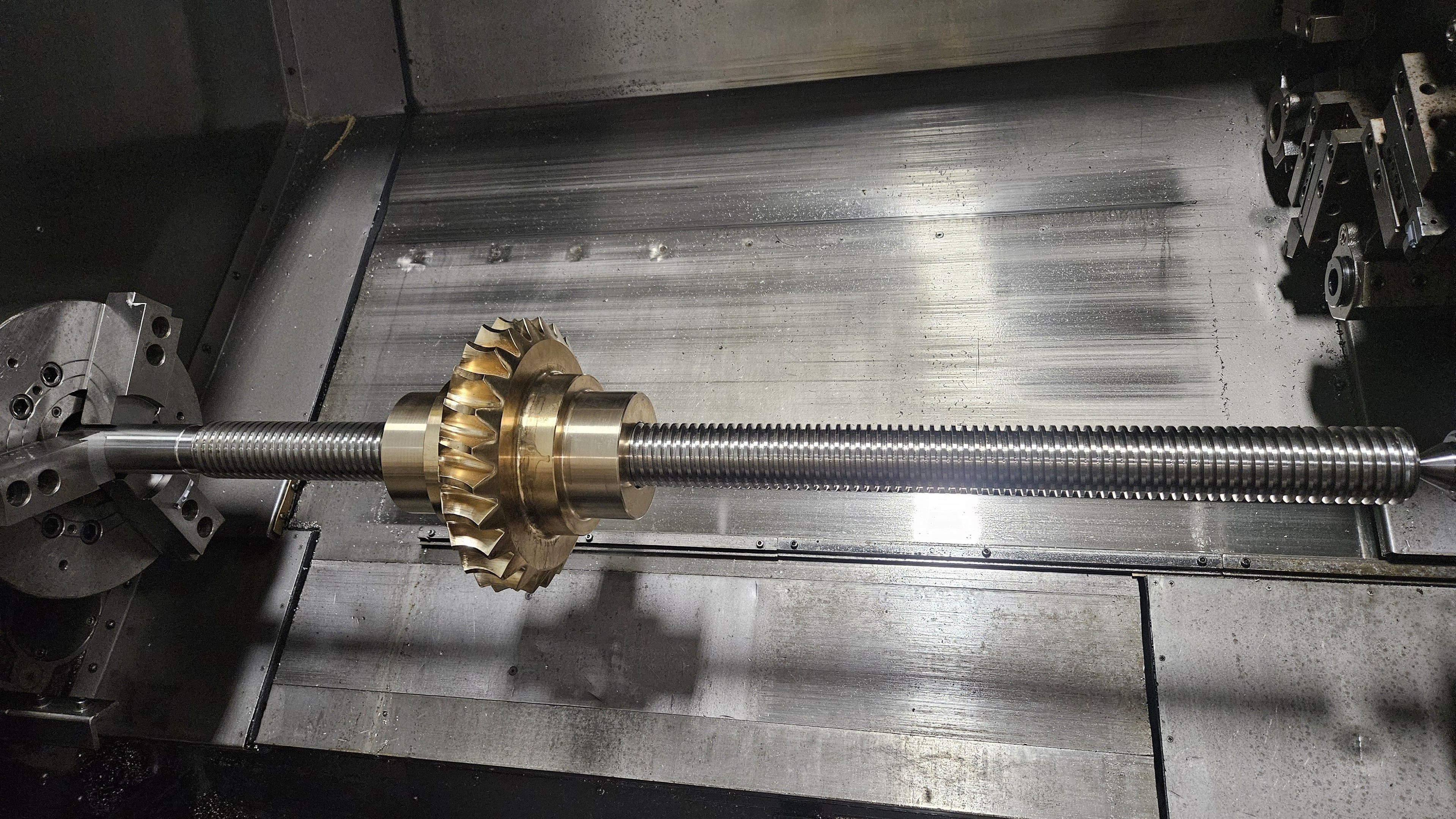 Bronze bevel gear cut onto a lead screw shaft on a lathe